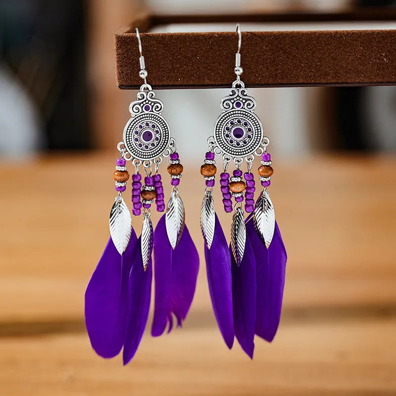 Round drop feather earrings with leaf patterning in alloy, available in multiple electroplated colours.