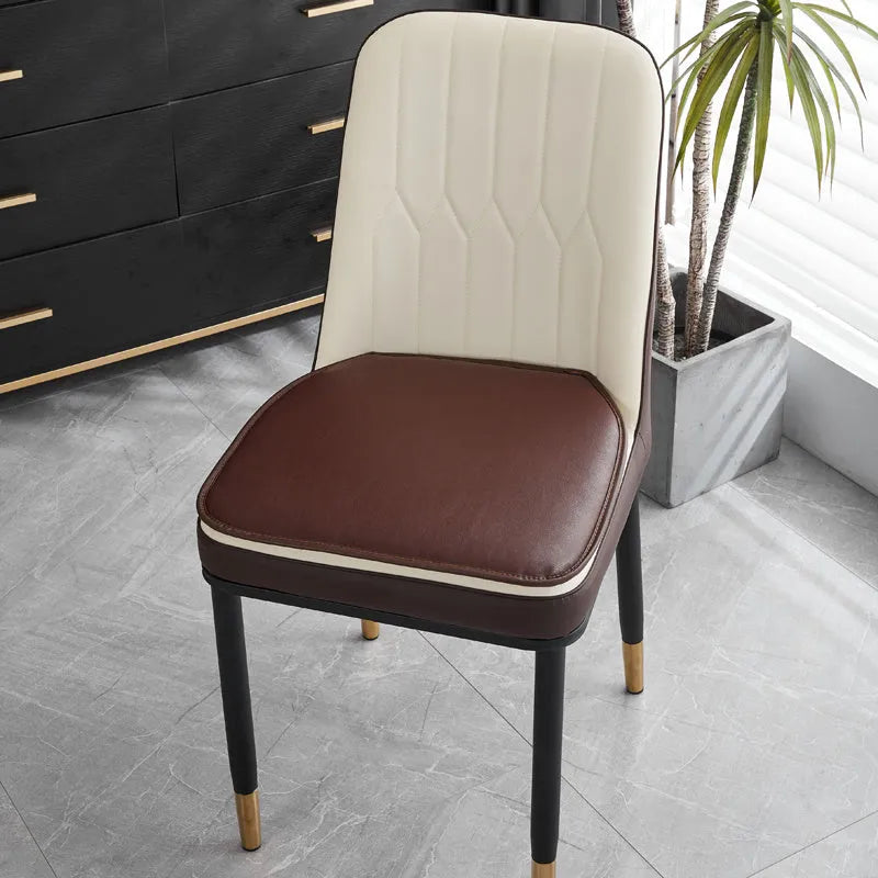 Leather horseshoe-shaped seat cushion in beige colour on a wooden chair, showing non-slip base.