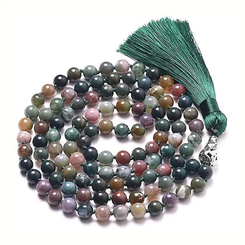 Long geometric agate and gemstone tassel necklace with blue, purple, and multi-coloured beads on a black background.