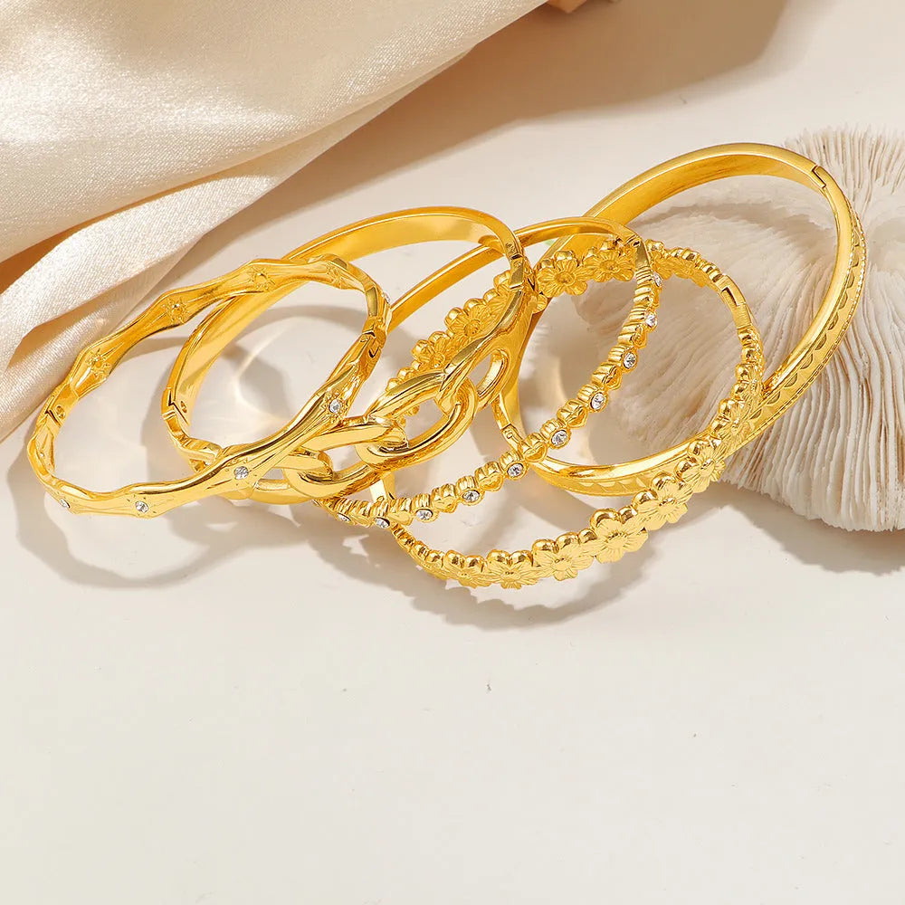 Titanium steel 18K gold electroplated bracelet with round zircon accents in SZ67 Gold colour on a plain background