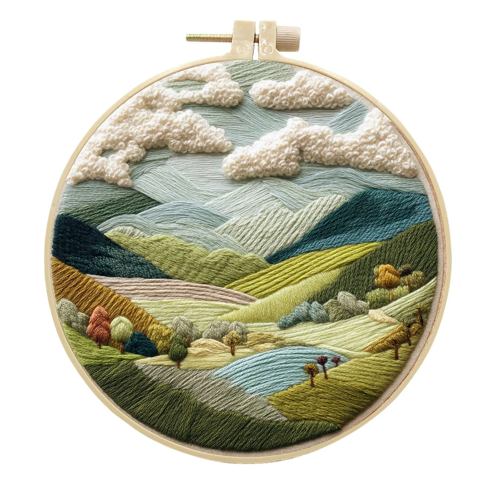 Embroidery DIY kit with bamboo frame, cotton fabric printed with a landscape scene, threads, and needles laid out