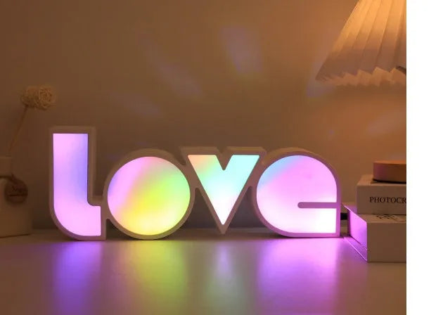 LED decorative light with rainbow-coloured LOVE word on plastic shade
