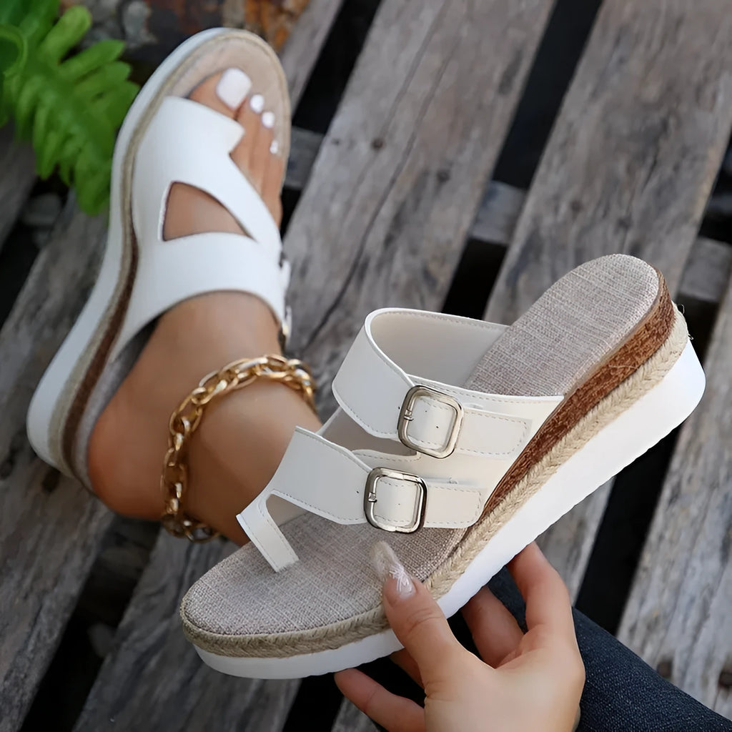 White patent leather wedge sandals with peep toe and woven finger fit straps