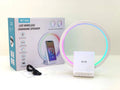 White rectangular smart Bluetooth speaker with integrated wireless charging pad and ambient light on a desk