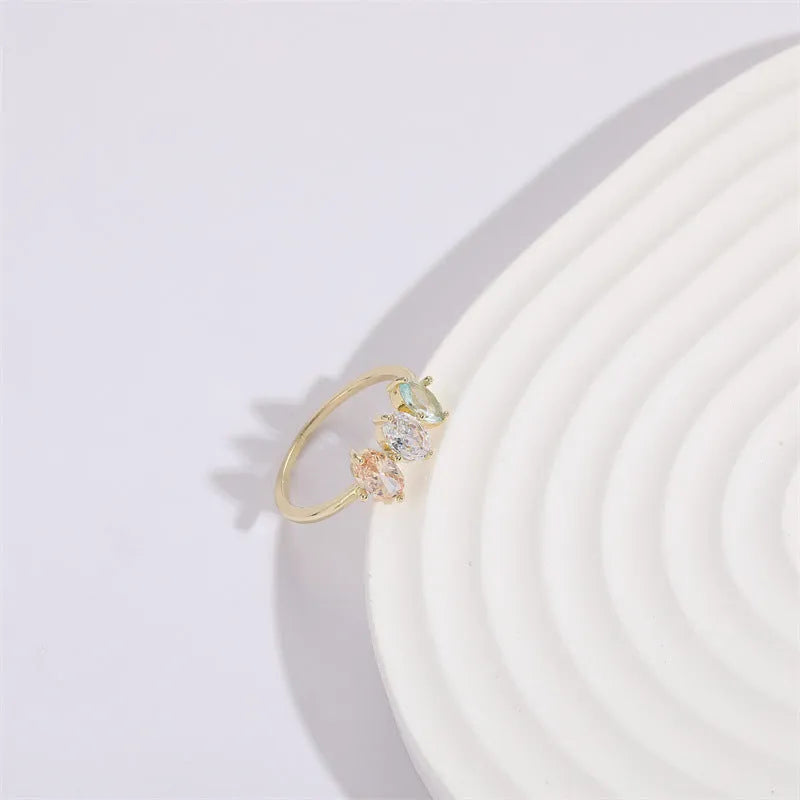 Geometric triangle ring with horse eye design and tricolour zircon stones in gold electroplated finish