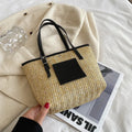Women's woven straw shoulder bag in retro style with three-dimensional pocket and visible sewing thread details