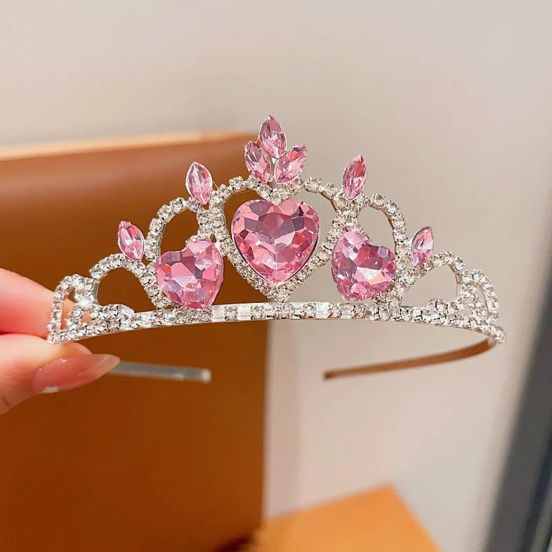 Children's electroplated alloy metal headband with crown shape and crystal decoration in pink, blue, or purple.