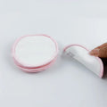 Set of four red and four blue velvet makeup remover pads next to a white cotton mesh bag.
