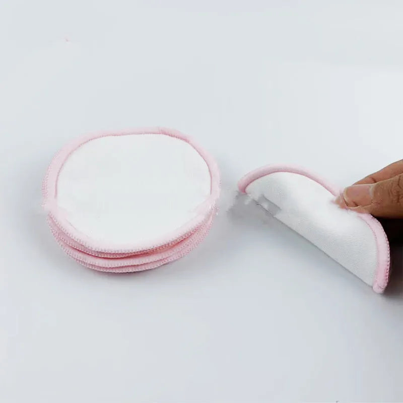 Set of four red and four blue velvet makeup remover pads next to a white cotton mesh bag.
