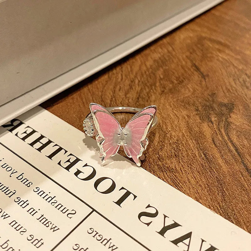 Copper butterfly women's ring with oil-drip finish showing open-loop design