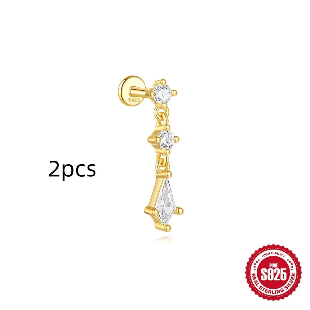 Geometric kite-shaped sterling silver stud earrings with rhinestones and a gold chain tassel.
