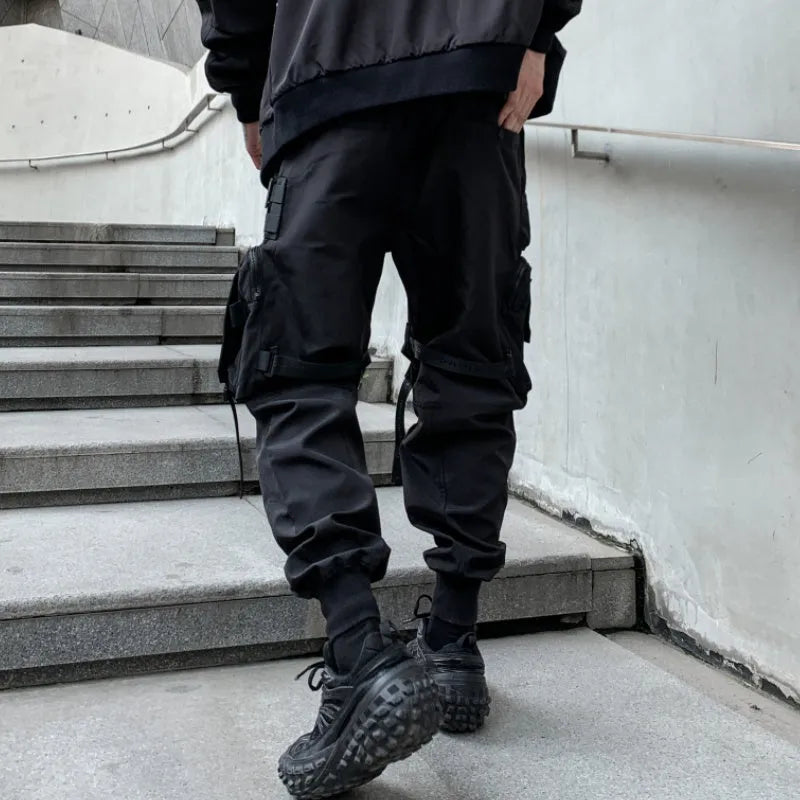 Men's black casual overalls loose fit binding hem trousers front view on mannequin