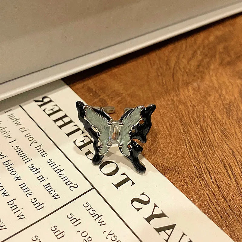 Copper butterfly women's ring with oil-drip finish showing open-loop design