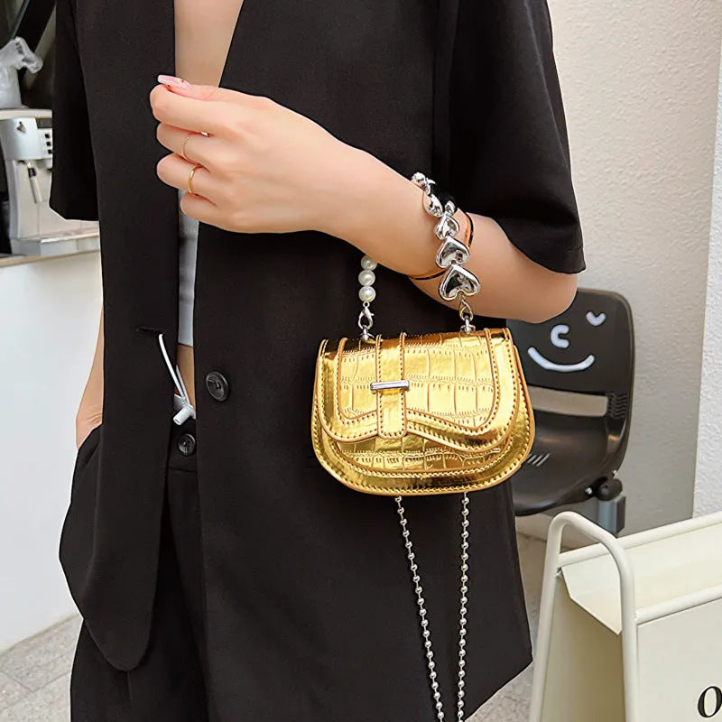 Silver laser pearl women's mini crossbody bag with a horizontal square shape and single shoulder strap.