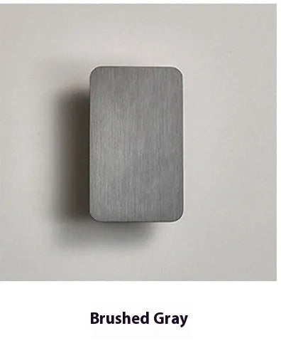 Slim minimalist Nordic-style LED wall lamp mounted on a wall, shown in a choice of colours and sizes.