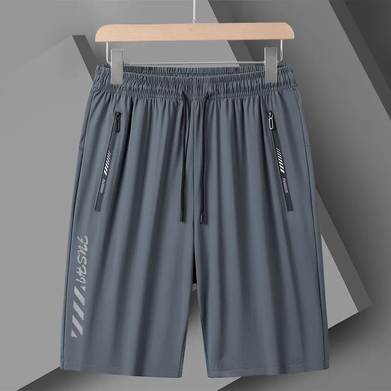 Man wearing black loose-fit quick-drying nylon sports shorts with a five-inch length.
