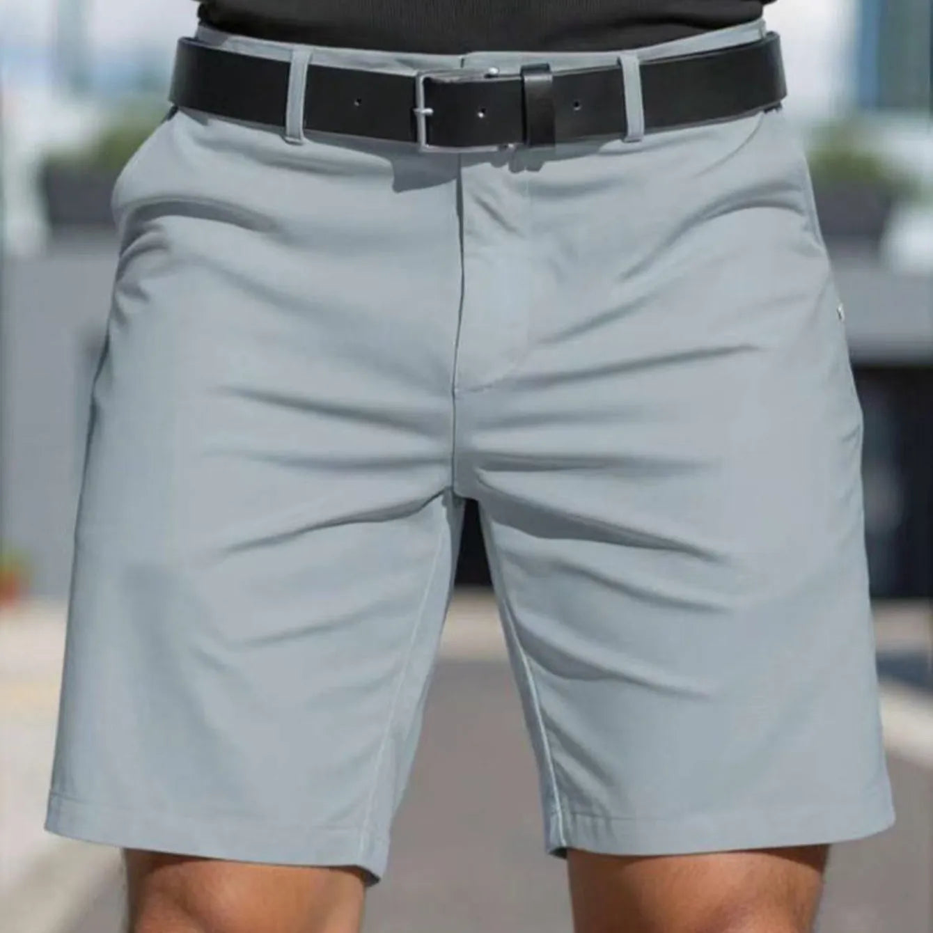 Men's straight cut solid colour shorts in light blue, showing fifth pants length and micro elastic polyester fabric.