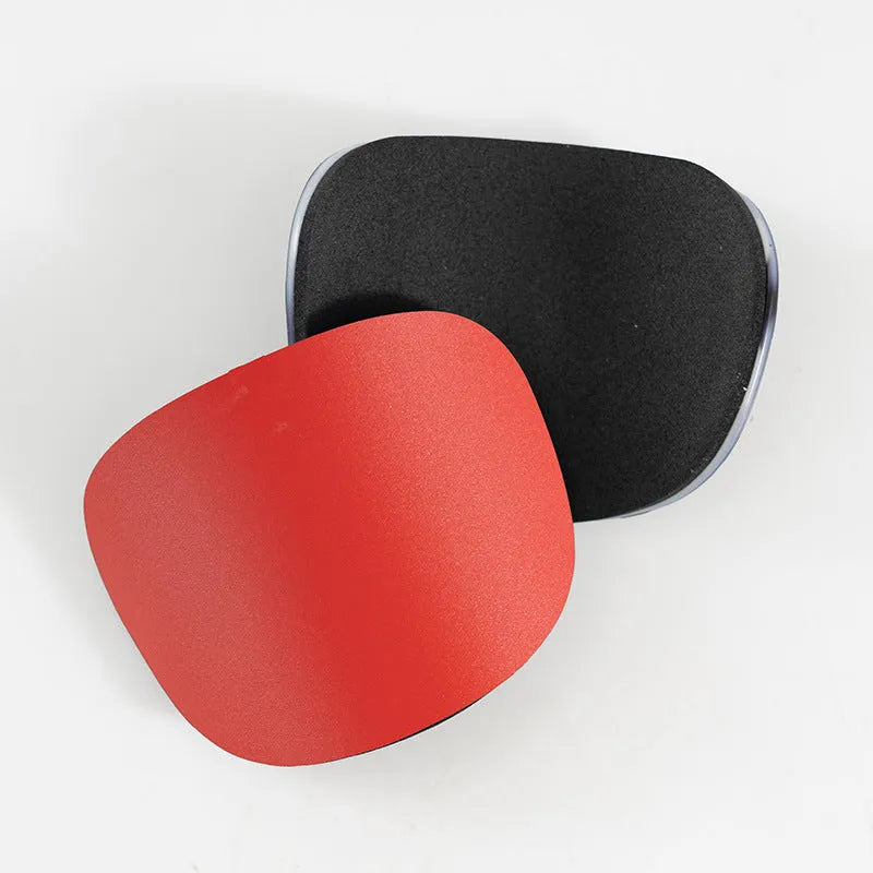 Two pairs of PU mini shin guards in black, white, red, and dream blue colours on a sports field.