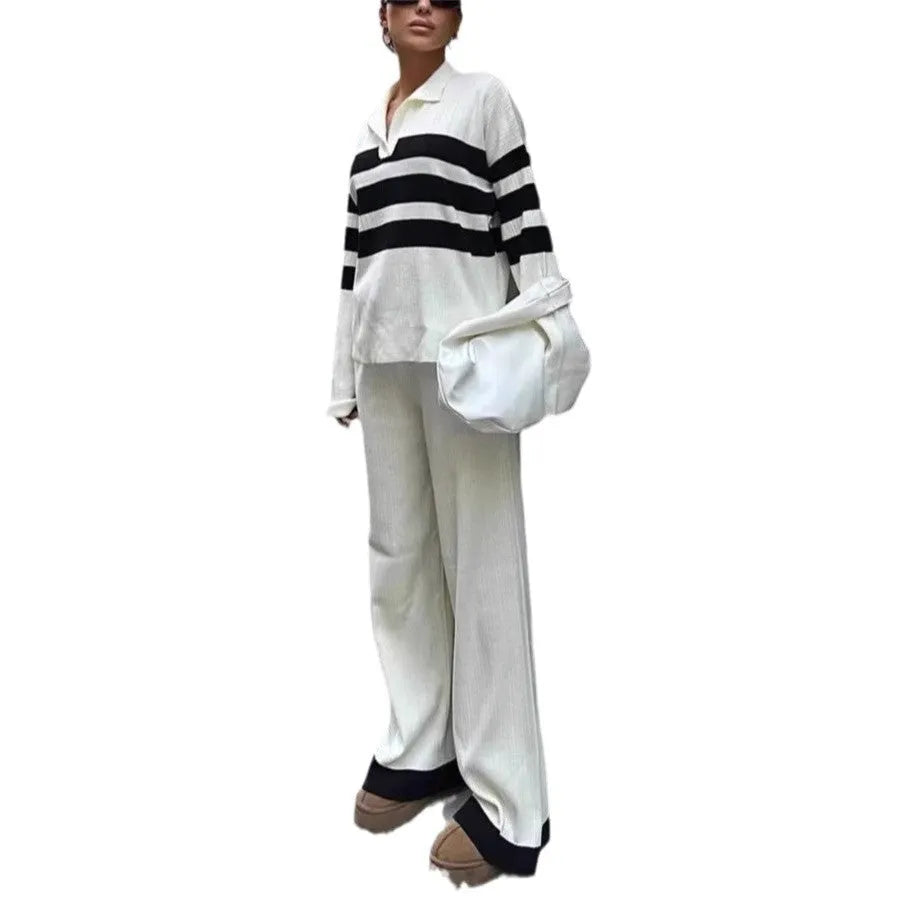 Women's black knitted two-piece set with polo collar top and straight-leg trousers.