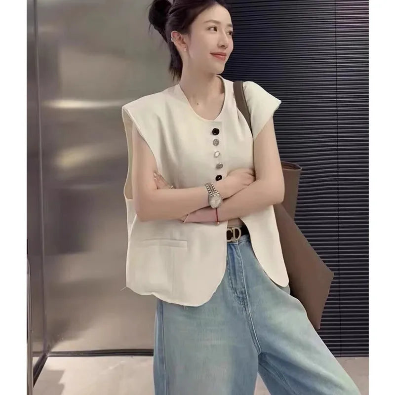 Women's loose-fit short polyester vest in milky white with pocket detail.