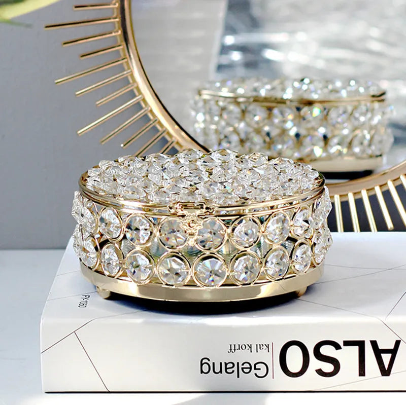 French gold iron frame crystal glass jewellery box with a metal lock closed.