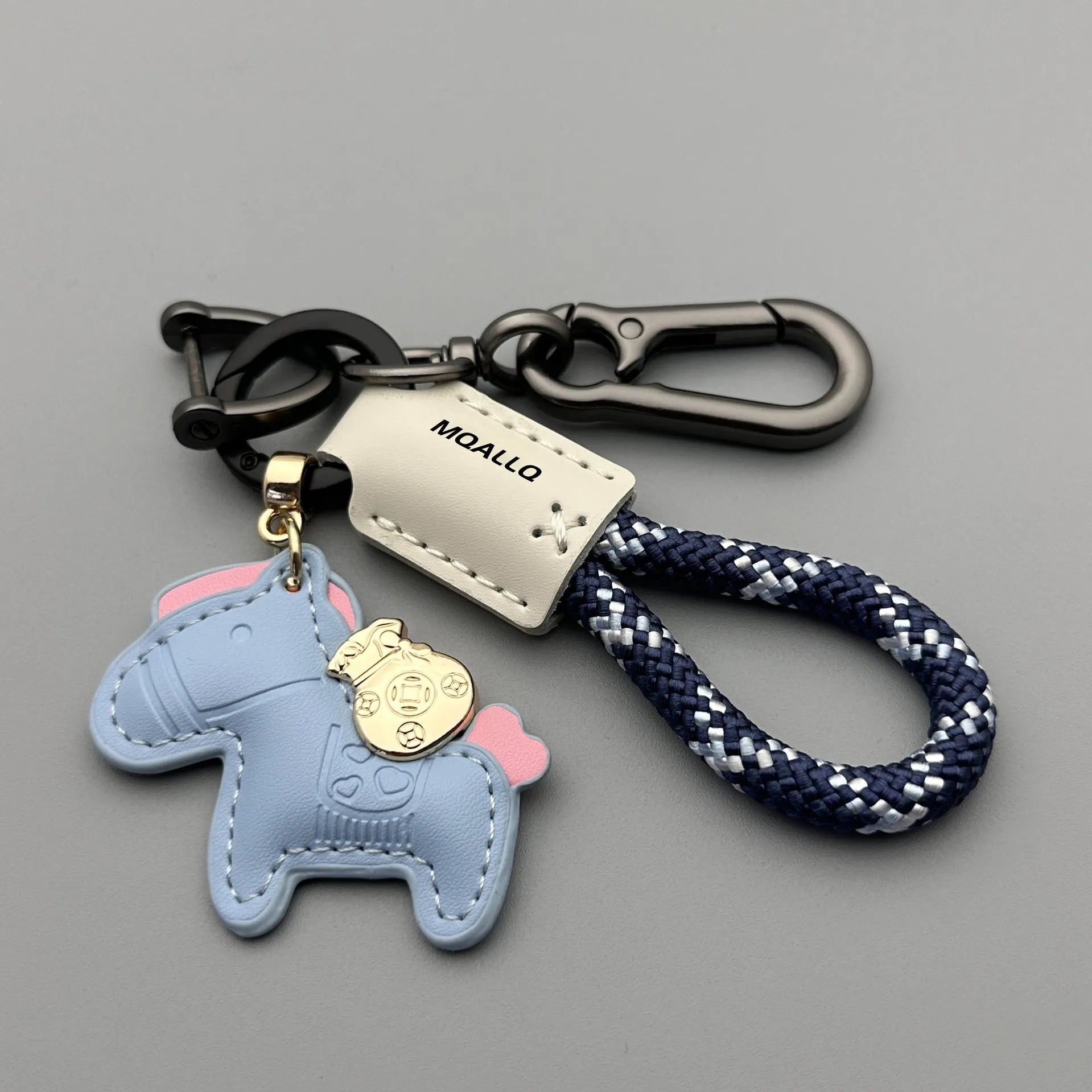 Zinc alloy car keychain pendant with a strap made of brown cowhide and green flannel rope.