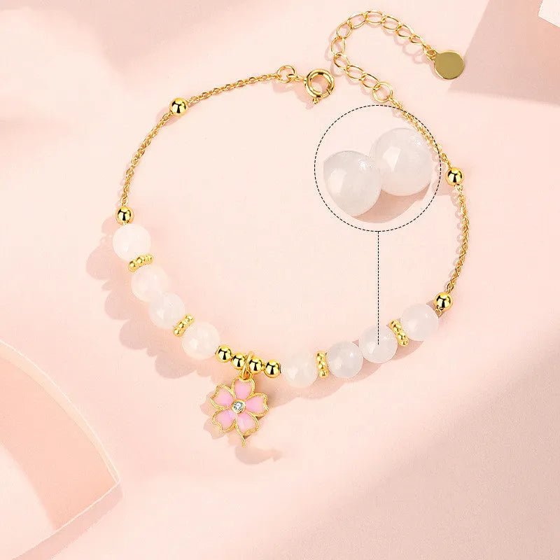 S925 silver bracelet with pink gradient cherry blossom pendant and Hetian jade beads on display