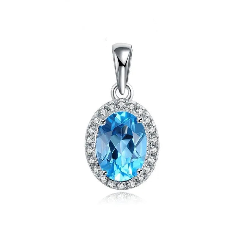 Geometric blue topaz and sterling silver four-piece jewellery set with earrings, ring, pendant, and necklace.