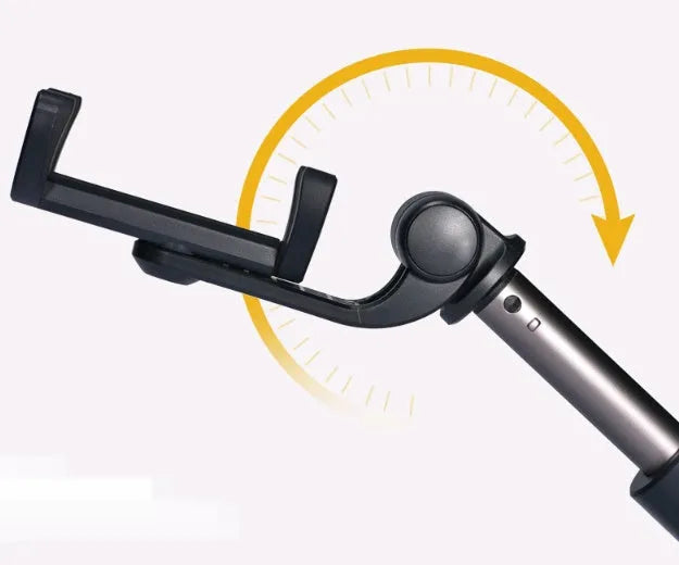 Aluminium Bluetooth selfie stick with tripod legs extended and wireless remote on a table