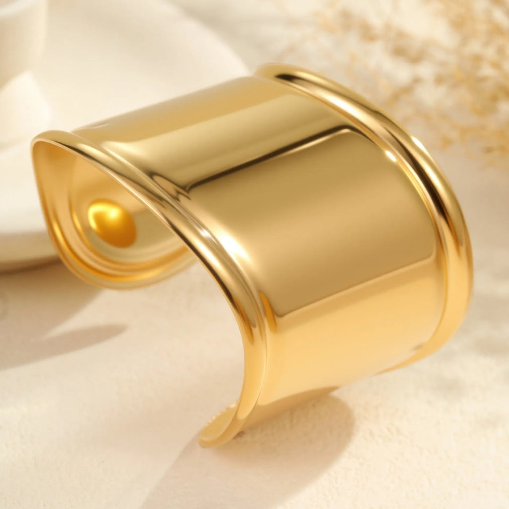 Gold plated wide women's bracelet with geometric wave design and niche opening