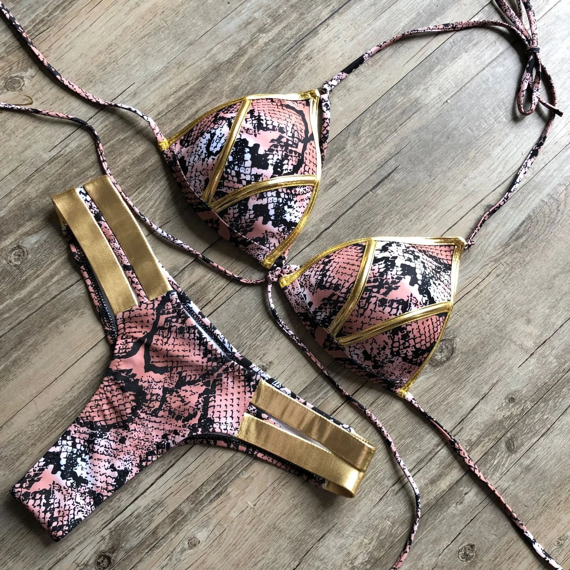 Women's bronzing bikini swimsuit with padded cups and cotton lining in multiple colour and print options.