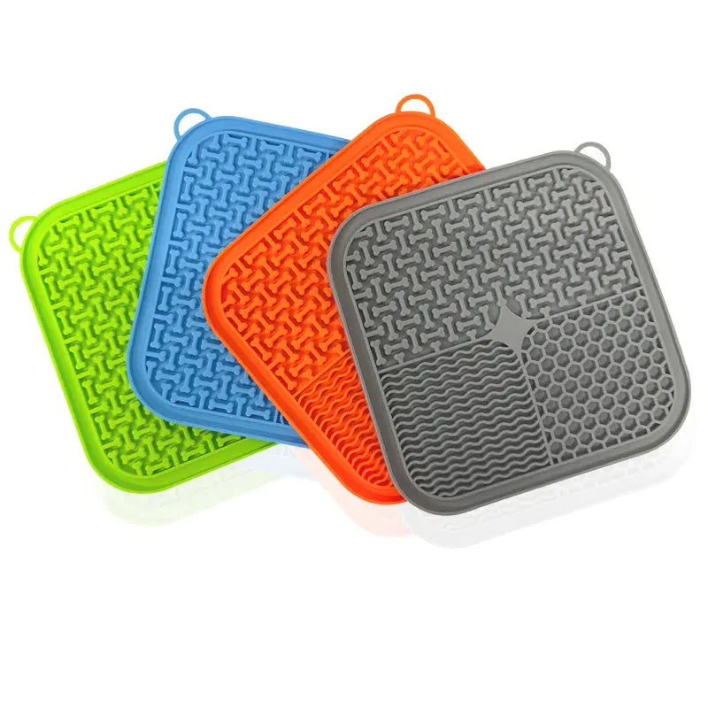 Square orange and blue silicone dog licking mat with textured surface and suction cups on the back.