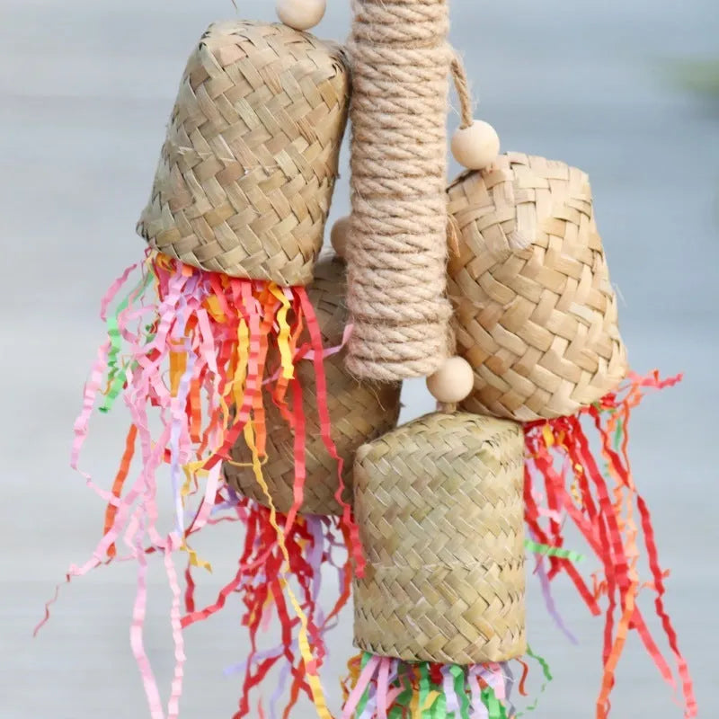 Colourful parrot chew toy with wood base, sisal rope and blue shredded paper attachments