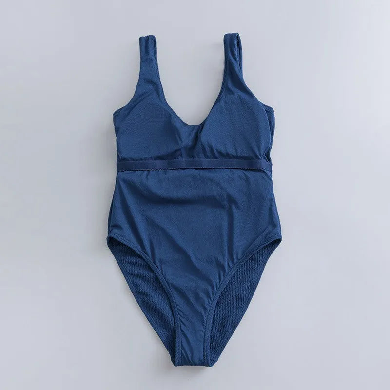 Navy blue women's one-piece swimsuit with slimming triangle design and built-in chest pad