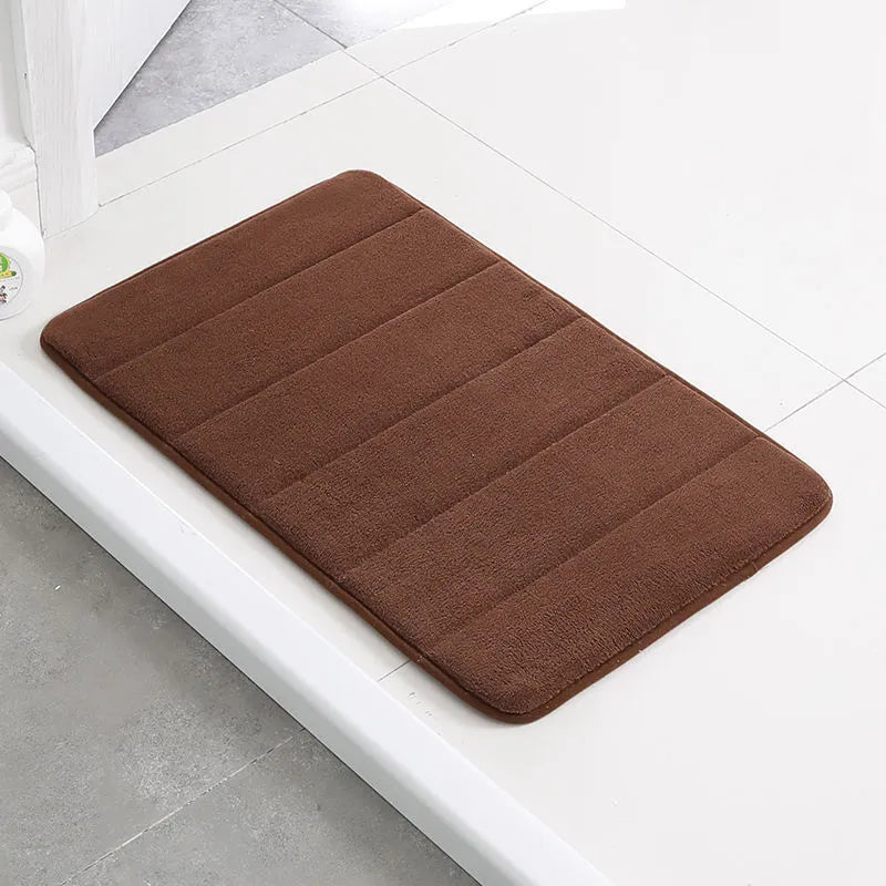 Coral fleece non-slip bath mat in 40x60cm size, placed on bathroom floor with water absorbent surface