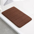Coral fleece non-slip bath mat in 40x60cm size, placed on bathroom floor with water absorbent surface