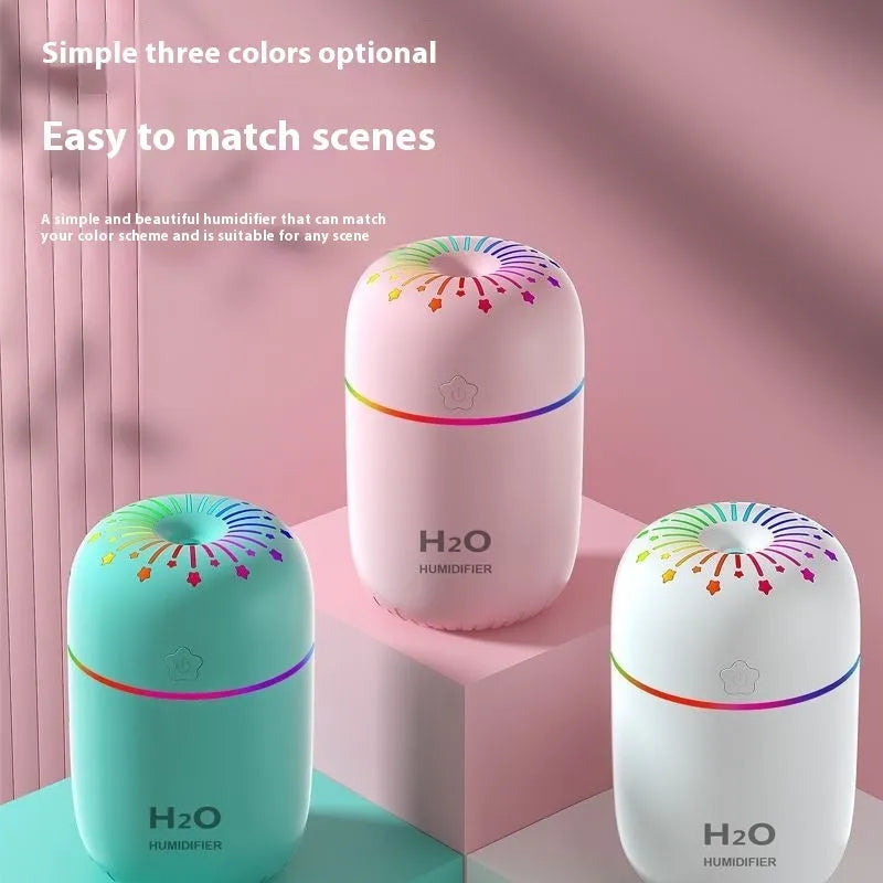 Small white USB personal humidifier with water tank on a wooden desk.