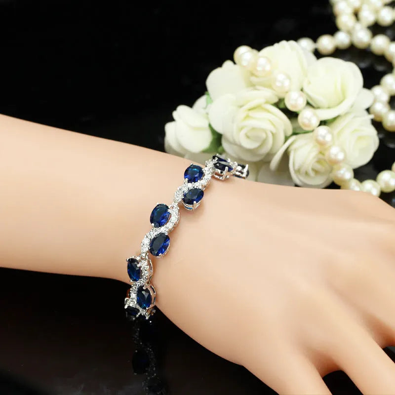 18K copper electroplated gold bracelet with AAA+ zircon stones in a simple geometric shape on a wrist.