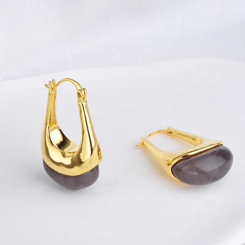 Copper geometry shape retro Maillard style earrings with electroplated finish in amber colour option on plain background