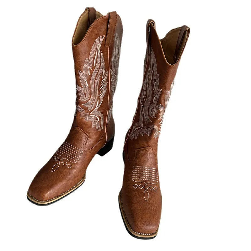Brown women's Martin boots with embroidered pattern and mid-calf length, showing low square heel and round toe