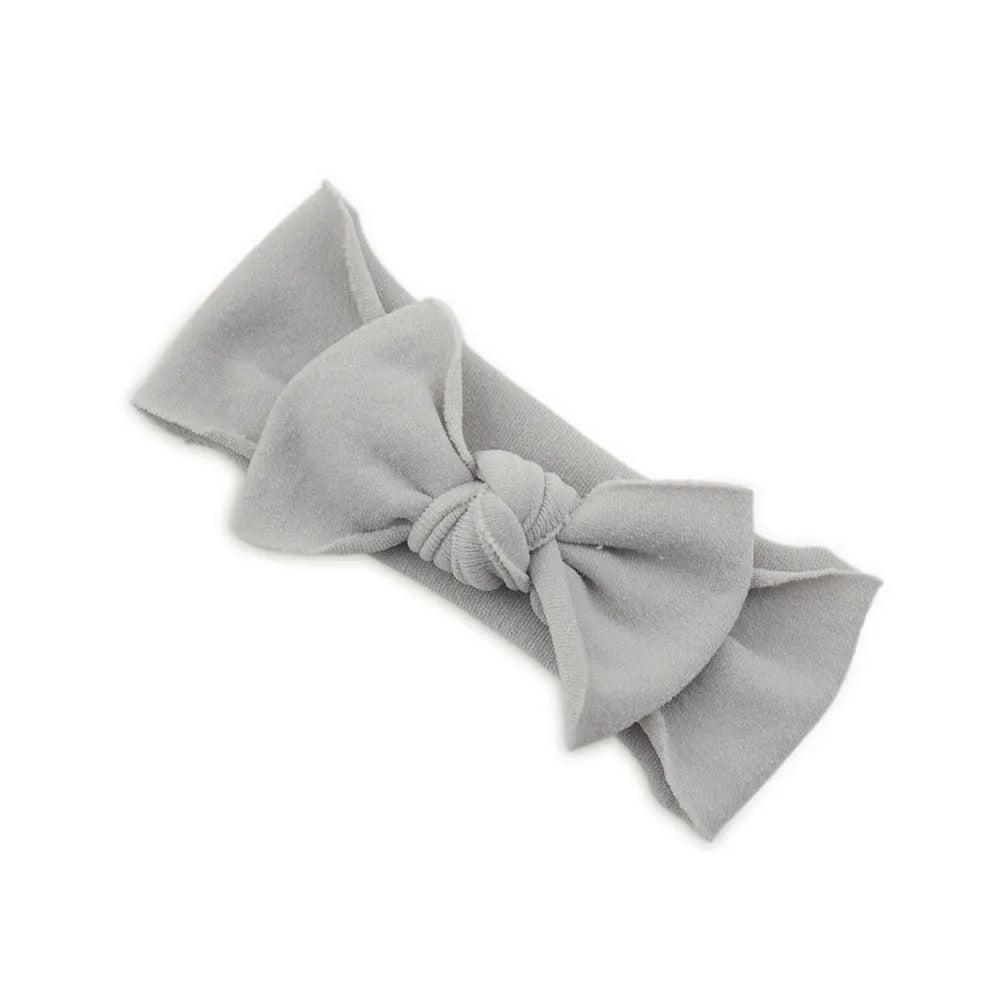 Solid colour knotted cloth headband for baby girls with bowknot design, available in 37 colours
