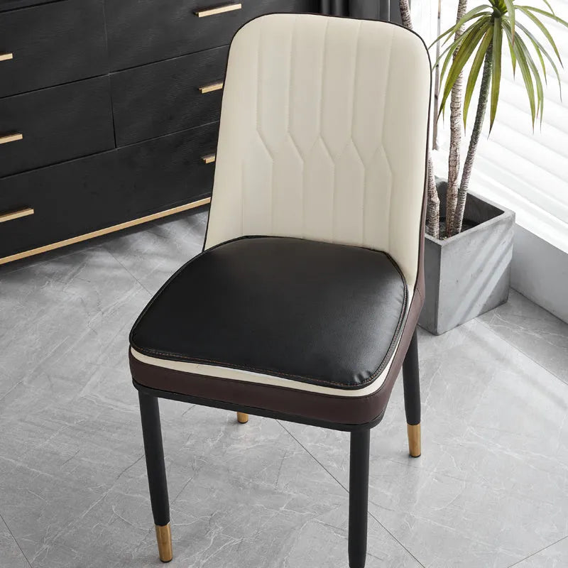 Leather horseshoe-shaped seat cushion in beige colour on a wooden chair, showing non-slip base.
