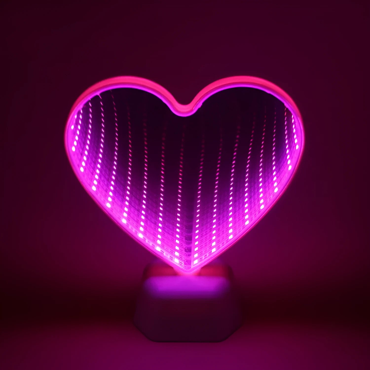 Rose red LED double-sided love tunnel light on a tabletop showing its plastic construction and dimensions.