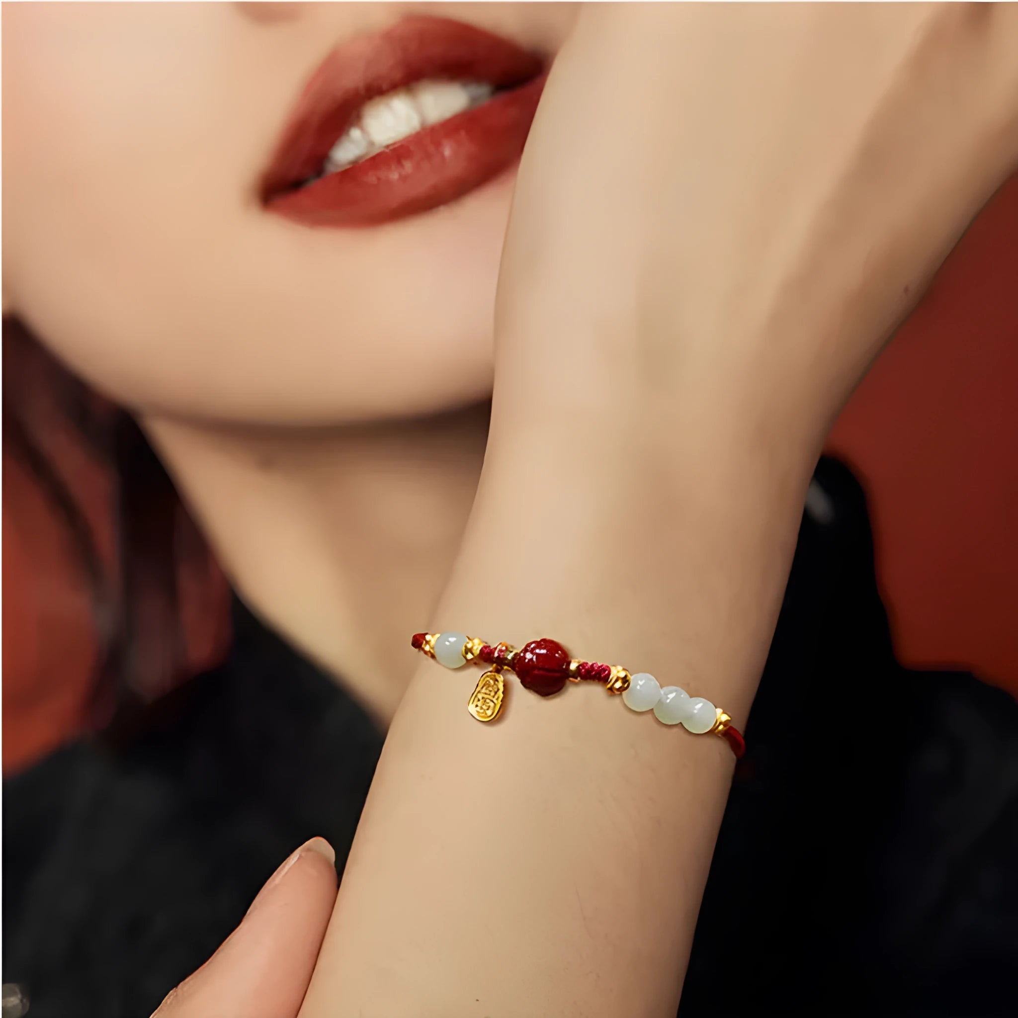 Hetian jade and cinnabar red rope women's bracelet with adjustable sterling silver chain.