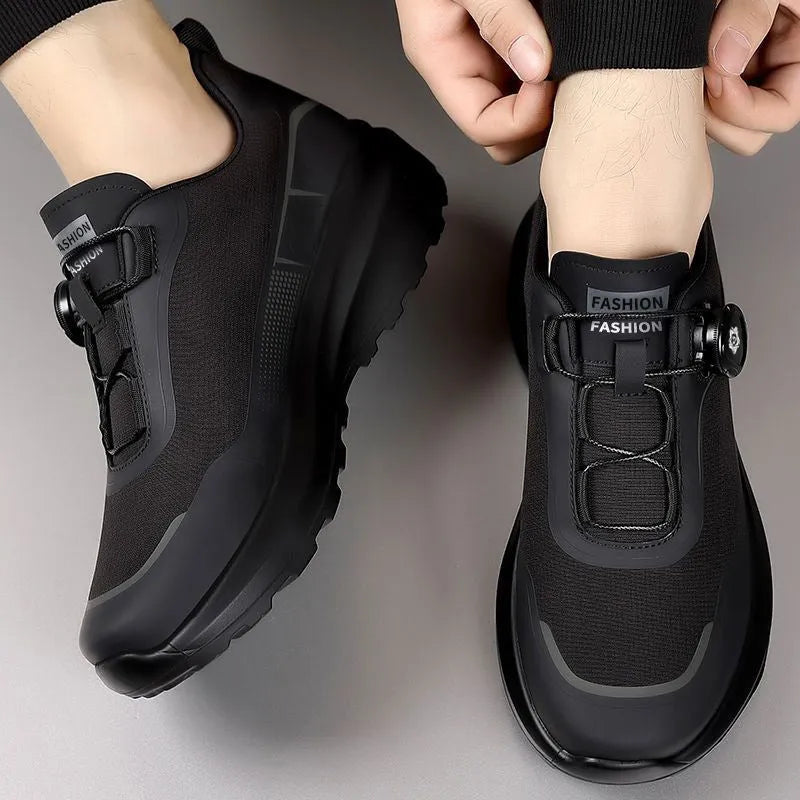 Men's black casual sneakers with a rotating button closure and thick platform sole.