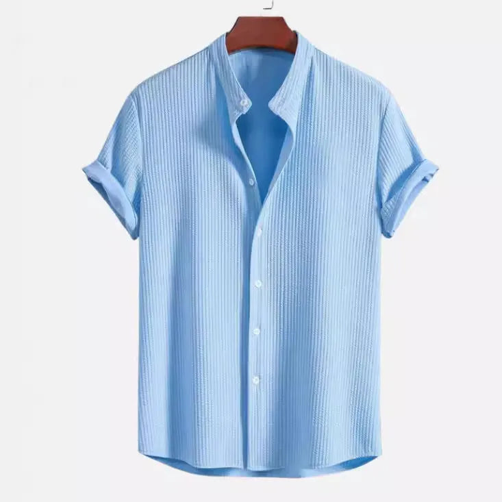 Man wearing a loose-fit short sleeve casual shirt in a solid colour, available in multiple sizes.
