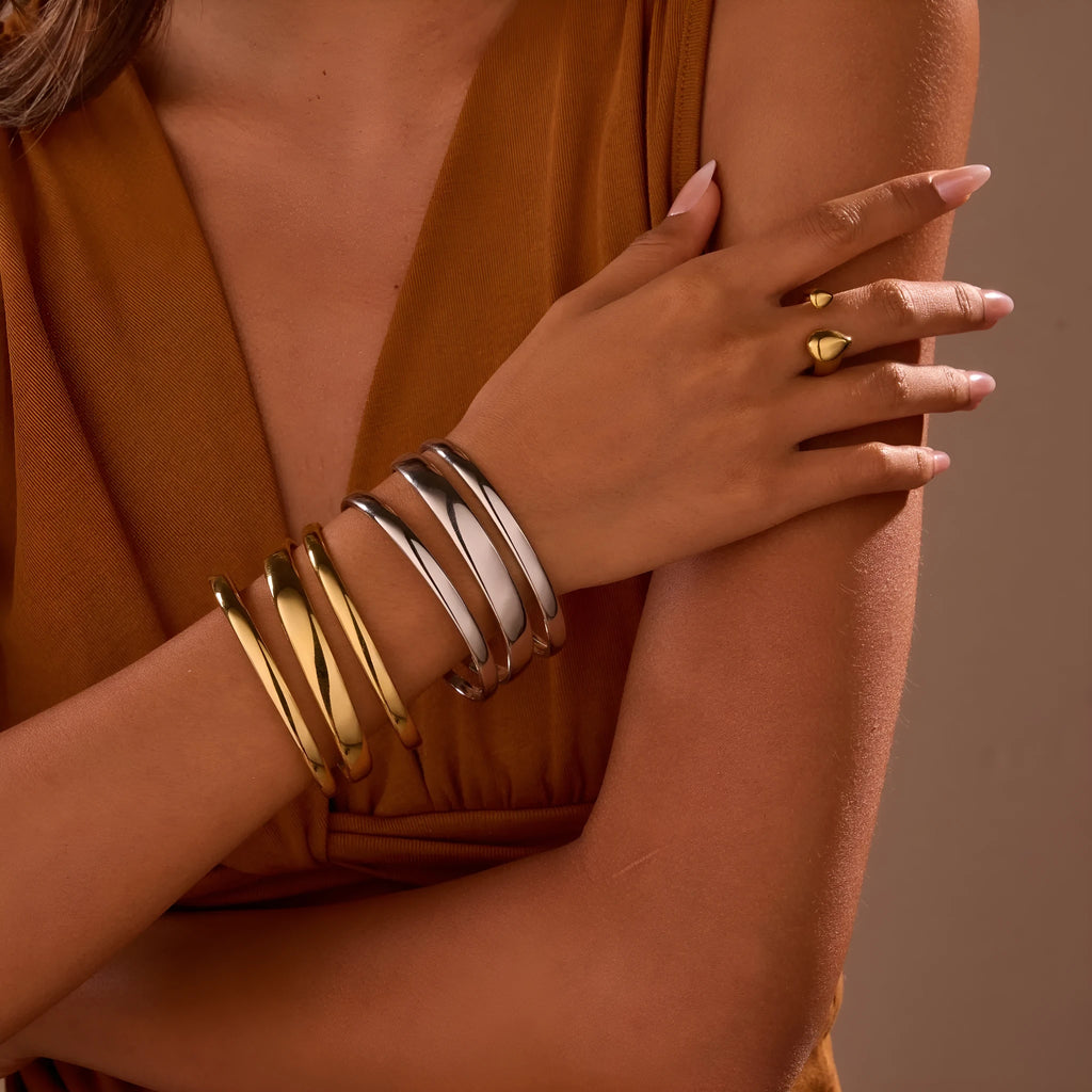 Geometric stainless steel women's bracelet with a simple opening, shown in gold and steel colour options.
