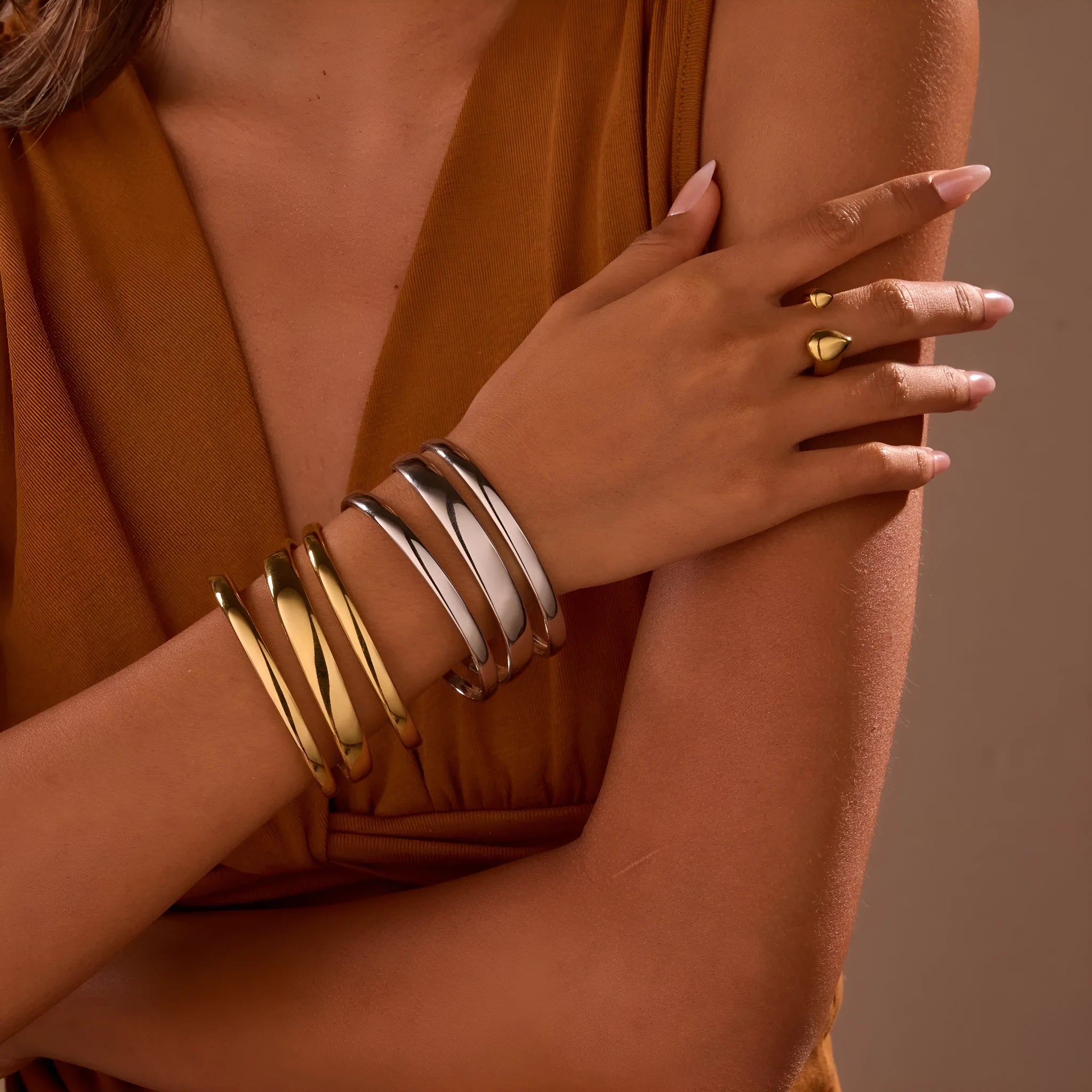 Geometric stainless steel women's bracelet with a simple opening, shown in gold and steel colour options.