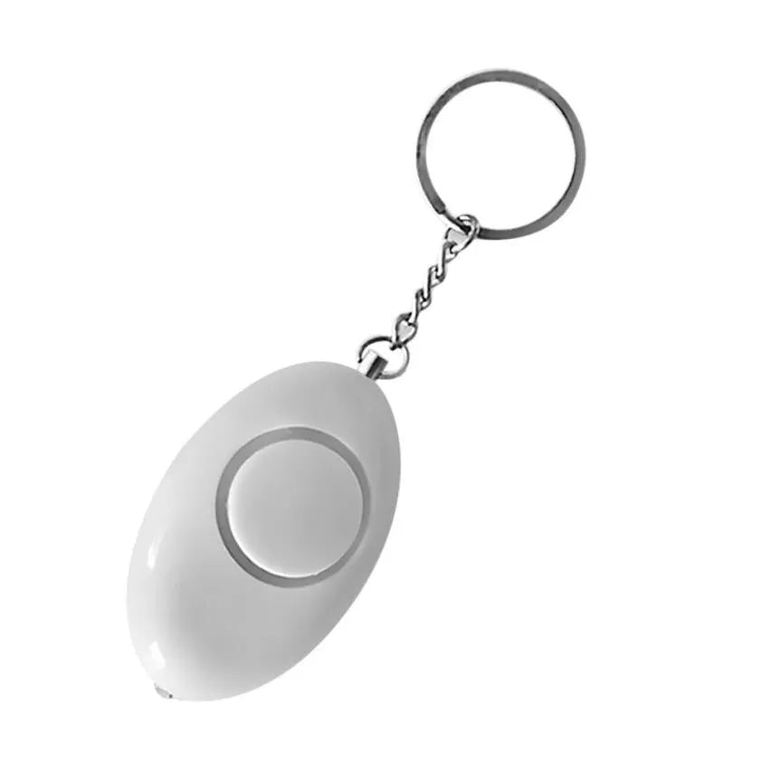 Egg-shaped personal safety alarm keychain in pink with metal pin on a white background