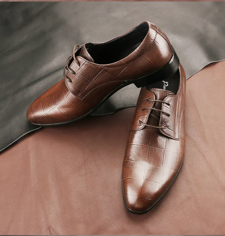 Men's black handcrafted leather derby shoes with a pointed toe and rubber sole.